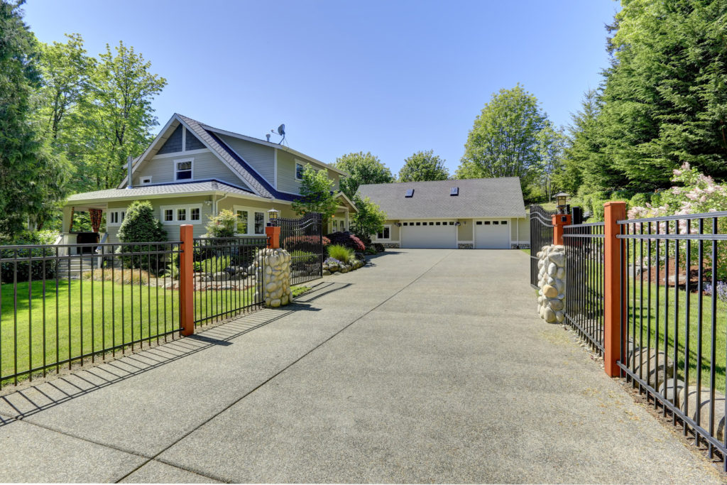 View of open entrance iron gates and driveway.